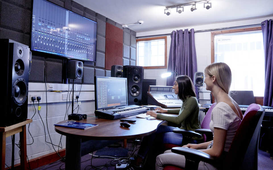 Students using equipment in studio